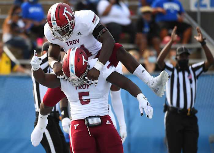 Sep 19, 2020; Murfreesboro, Tennessee, USA; Troy Trojans defensive tackle Will Choloh (5) and Troy Trojans linebacker Javon Solomon (41) celebrate after a safety during the first half against the Middle Tennessee Blue Raiders at Floyd Stadium. Mandatory Credit: Christopher Hanewinckel-USA TODAY Sports  
